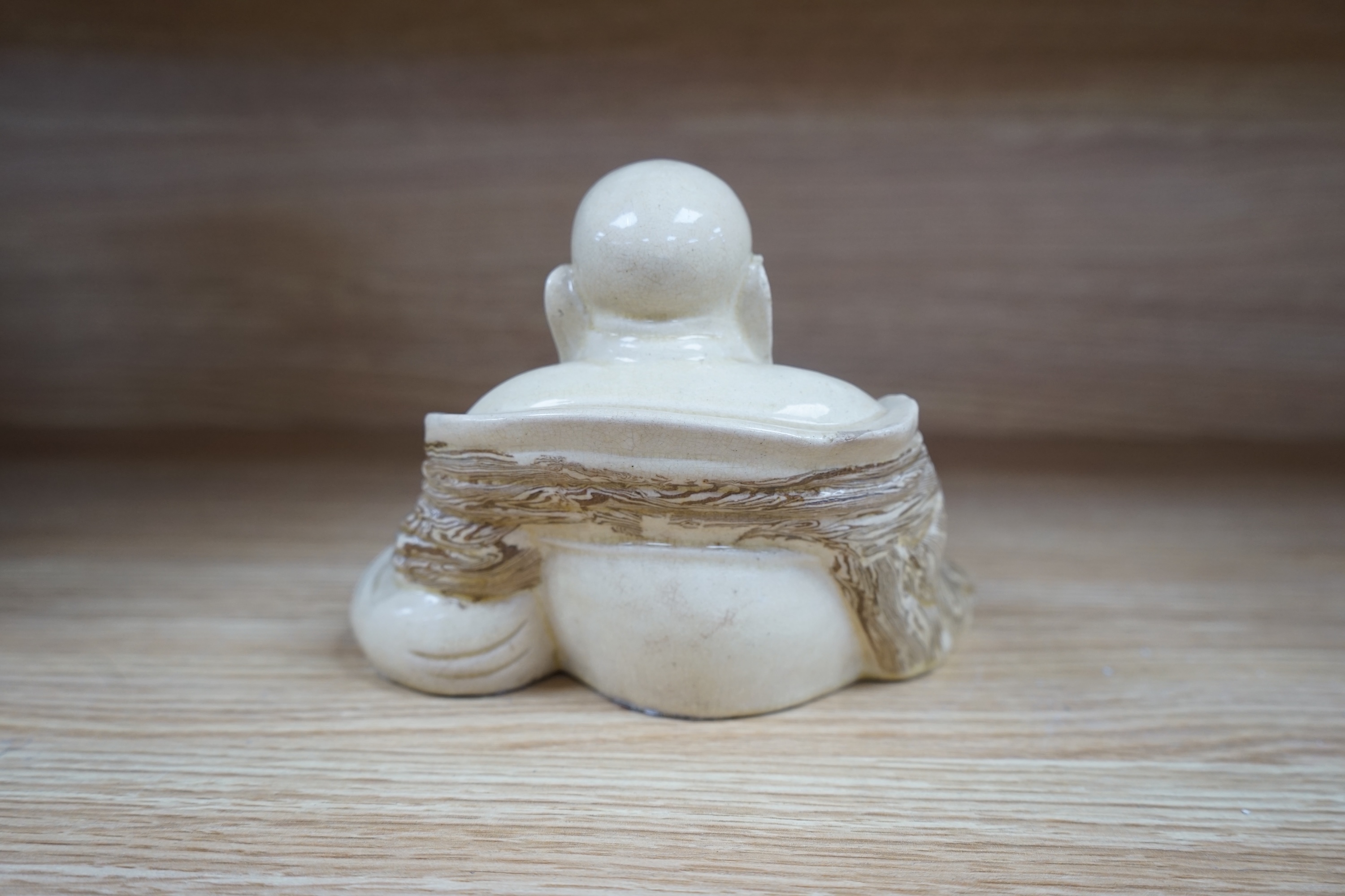 A Chinese marbled pottery figure of Budai, early 20th century, 13cm high. Condition - fair to good.